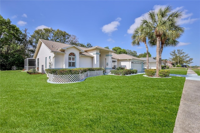 mediterranean / spanish house with an attached garage, driveway, stucco siding, and a front yard