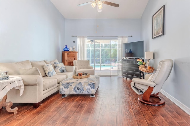 living room featuring baseboards, a ceiling fan, and hardwood / wood-style flooring