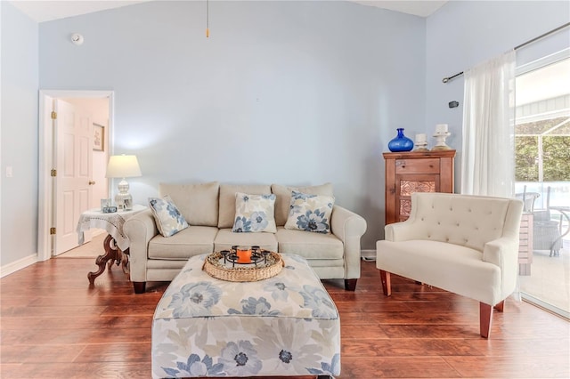 living area with wood-type flooring and baseboards