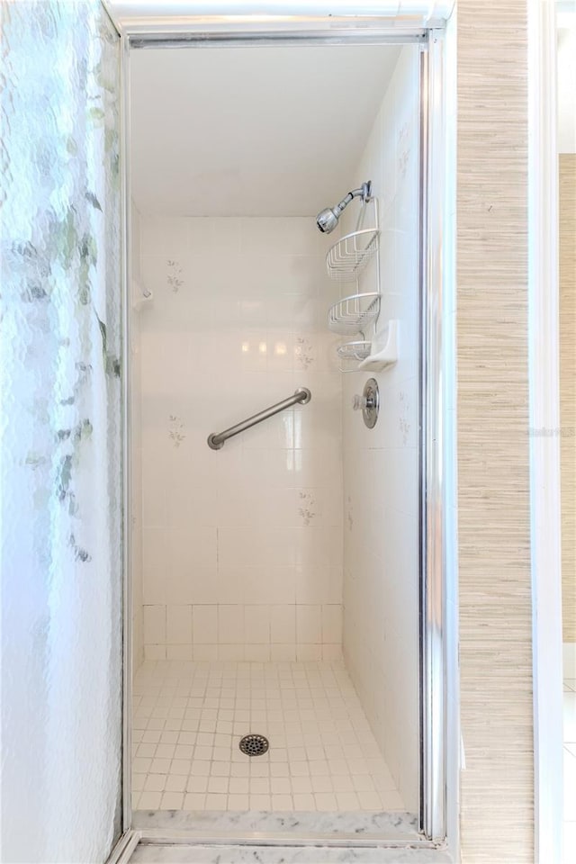 full bathroom with tile patterned floors and a stall shower