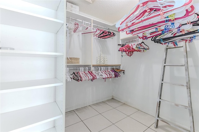 walk in closet featuring tile patterned flooring