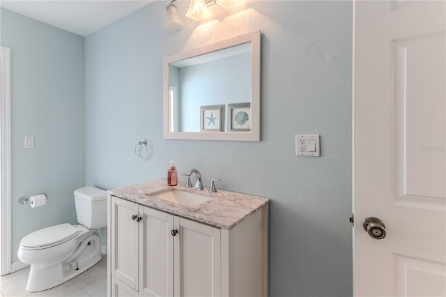 half bathroom with toilet, tile patterned floors, and vanity