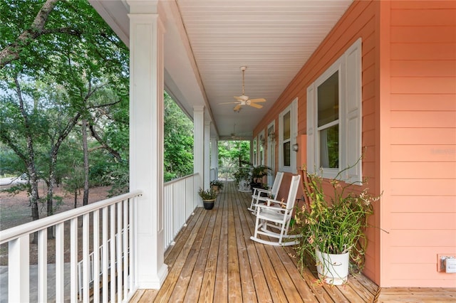 wooden terrace featuring a porch and a ceiling fan