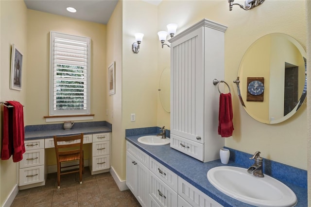 bathroom featuring double vanity, baseboards, a sink, and tile patterned flooring