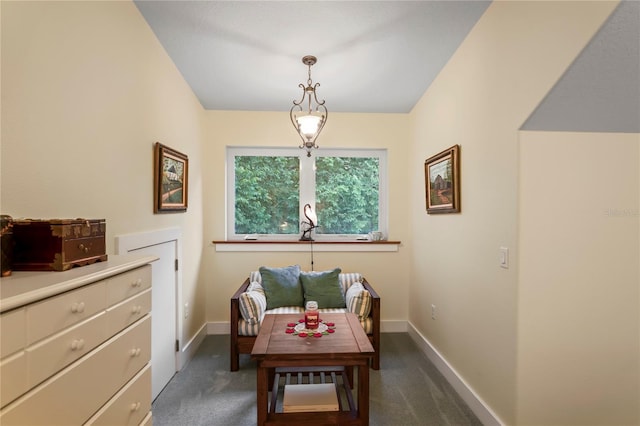 living area featuring baseboards and carpet flooring