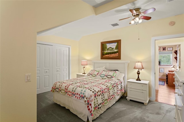 bedroom with visible vents, a ceiling fan, carpet floors, and a closet