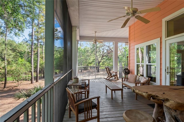 sunroom featuring ceiling fan and outdoor lounge area