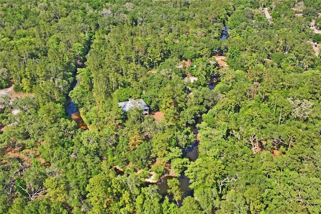 birds eye view of property with a view of trees