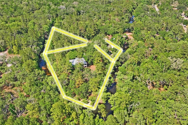 drone / aerial view featuring a forest view