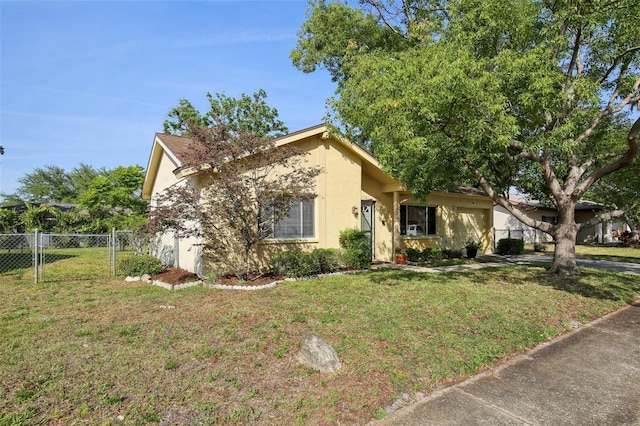 12906 Sandburst Ln, Hudson, FL 34667 - view of front of home with fence, a gate, stucco siding, and a front lawn