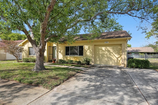 12906 Sandburst Ln, Hudson, FL 34667 - ranch-style house with fence, an attached garage, a front lawn, stucco siding, and driveway