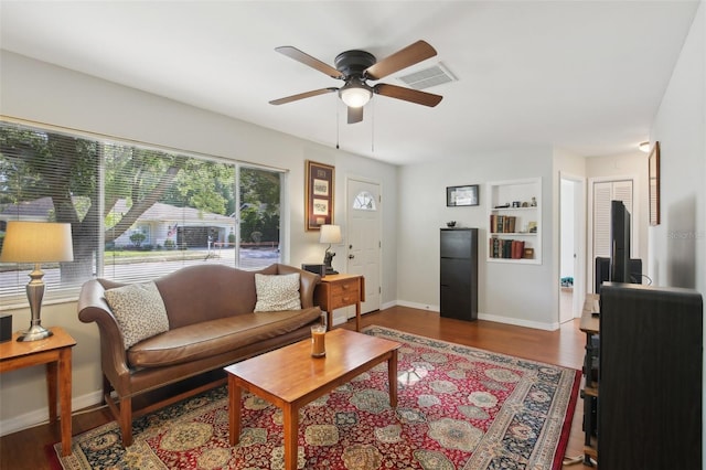 12906 Sandburst Ln, Hudson, FL 34667 - living area with a ceiling fan, baseboards, visible vents, and wood finished floors