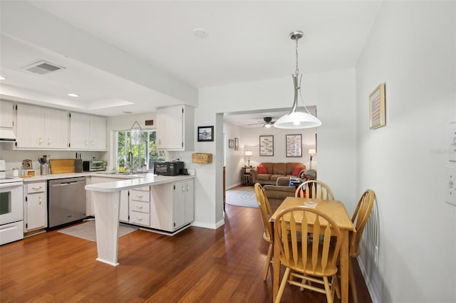 12906 Sandburst Ln, Hudson, FL 34667 - kitchen with visible vents, white range with electric cooktop, stainless steel dishwasher, light countertops, and a sink