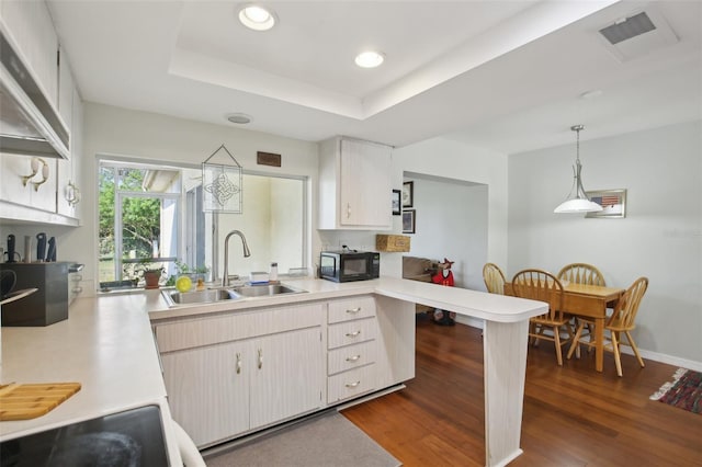 12906 Sandburst Ln, Hudson, FL 34667 - kitchen featuring visible vents, black microwave, light countertops, white cabinetry, and a sink