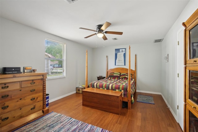 12906 Sandburst Ln, Hudson, FL 34667 - bedroom featuring baseboards, a ceiling fan, wood finished floors, and visible vents