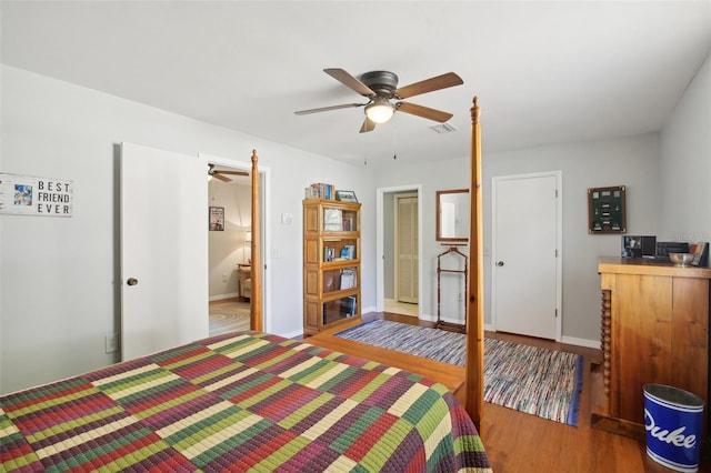12906 Sandburst Ln, Hudson, FL 34667 - bedroom with baseboards, ceiling fan, visible vents, and wood finished floors