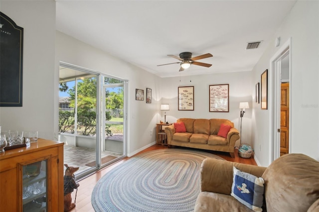 12906 Sandburst Ln, Hudson, FL 34667 - living area featuring baseboards, ceiling fan, visible vents, and wood finished floors