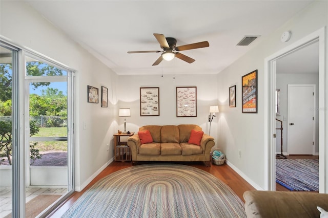 12906 Sandburst Ln, Hudson, FL 34667 - living area featuring a ceiling fan, baseboards, visible vents, and wood finished floors
