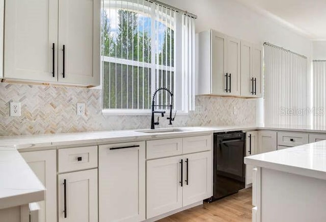 15906 Prince William Pl, Odessa, FL 33556 - kitchen with black dishwasher, a sink, light countertops, and decorative backsplash