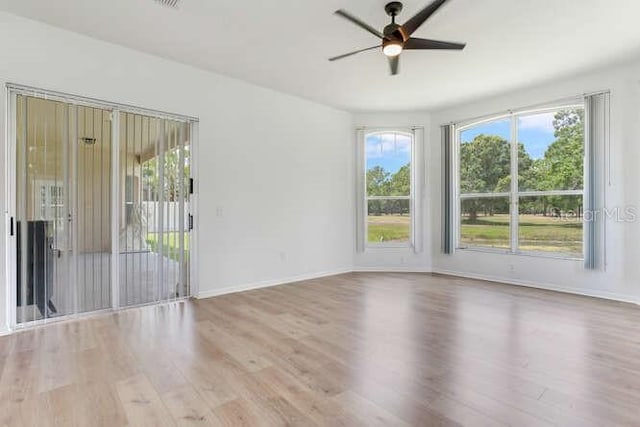 15906 Prince William Pl, Odessa, FL 33556 - unfurnished room featuring wood finished floors, a ceiling fan, healthy amount of natural light, and baseboards