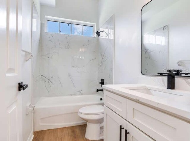 15906 Prince William Pl, Odessa, FL 33556 - full bath with toilet, shower / washtub combination, vanity, and wood finished floors