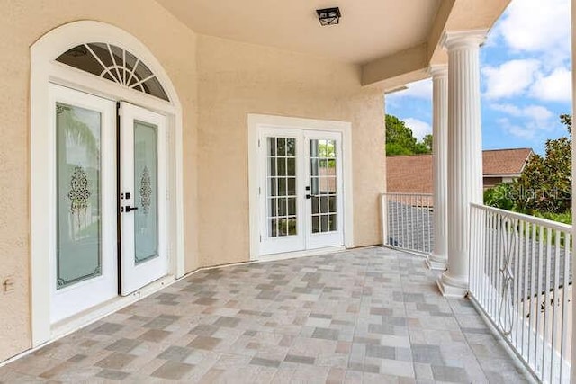 15906 Prince William Pl, Odessa, FL 33556 - property entrance with stucco siding, french doors, and a balcony