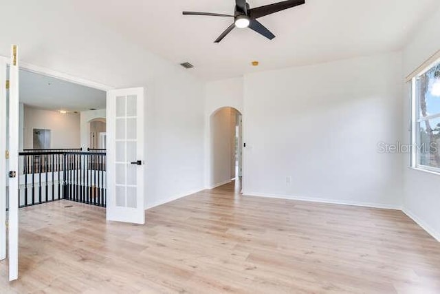 15906 Prince William Pl, Odessa, FL 33556 - unfurnished room with arched walkways, a ceiling fan, and wood finished floors
