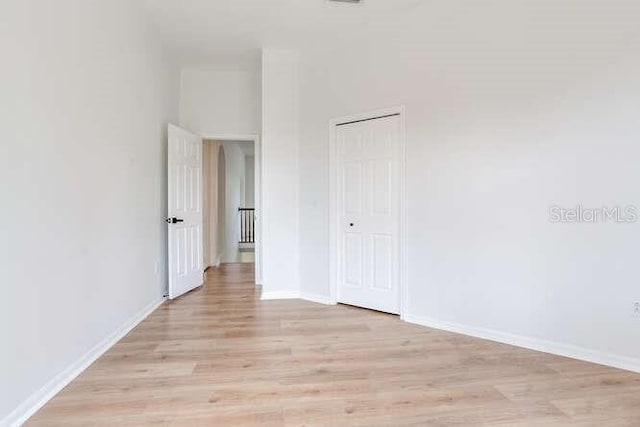15906 Prince William Pl, Odessa, FL 33556 - unfurnished bedroom featuring light wood-type flooring, baseboards, and a closet
