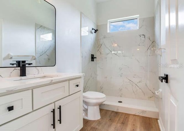 15906 Prince William Pl, Odessa, FL 33556 - bathroom featuring toilet, a marble finish shower, vanity, and wood finished floors