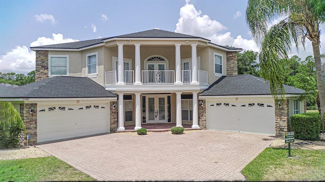 15906 Prince William Pl, Odessa, FL 33556 - greek revival house featuring french doors, stone siding, and a garage