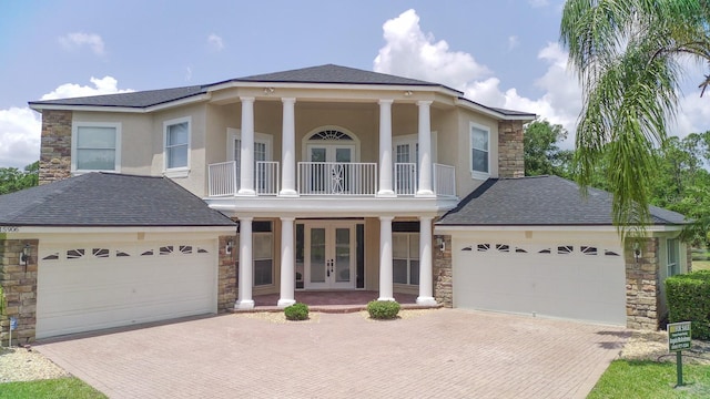 15906 Prince William Pl, Odessa, FL 33556 - greek revival inspired property with french doors, stone siding, and an attached garage