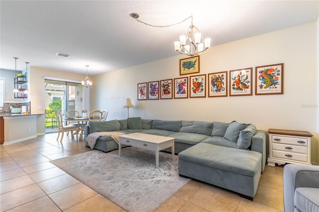 living area with a chandelier and light tile patterned flooring