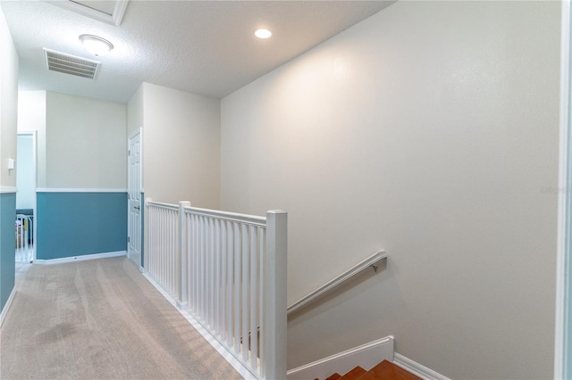 corridor featuring an upstairs landing, baseboards, recessed lighting, and carpet