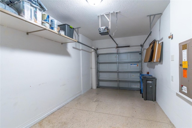 garage featuring a garage door opener and baseboards