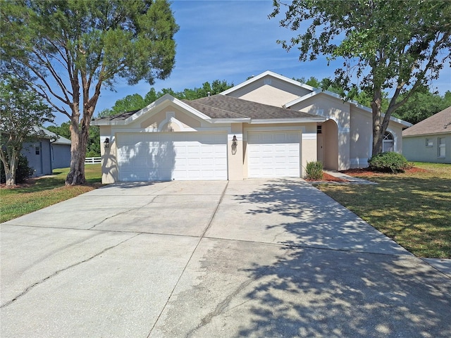 19855 Ellendale Dr, Land O Lakes, FL 34638 - ranch-style house with a garage, concrete driveway, stucco siding, and a front lawn