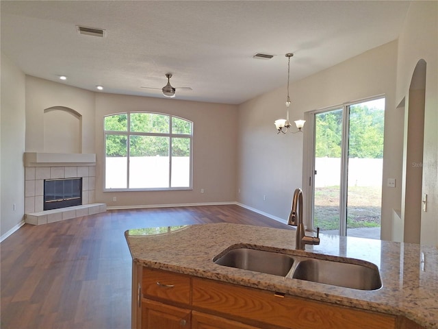 19855 Ellendale Dr, Land O Lakes, FL 34638 - kitchen with a sink, healthy amount of natural light, brown cabinetry, wood finished floors, and recessed lighting