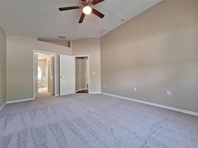 19855 Ellendale Dr, Land O Lakes, FL 34638 - unfurnished bedroom with light colored carpet, baseboards, ensuite bath, a ceiling fan, and lofted ceiling