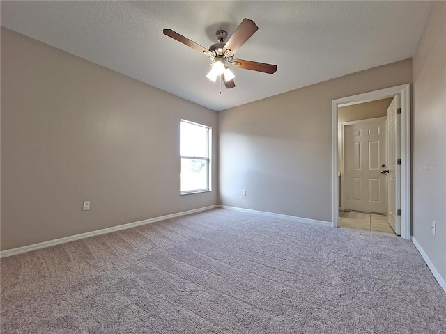 19855 Ellendale Dr, Land O Lakes, FL 34638 - empty room featuring light carpet, ceiling fan, baseboards, and a textured ceiling