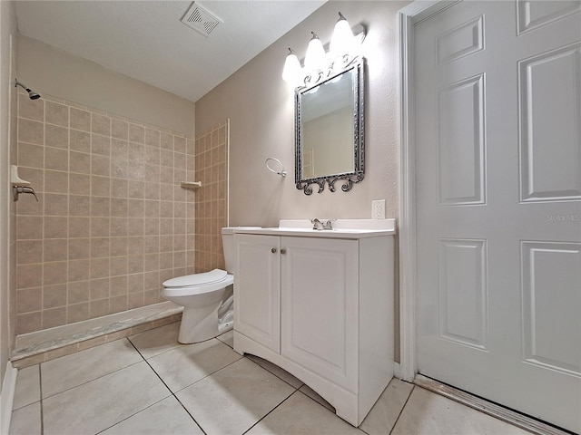 19855 Ellendale Dr, Land O Lakes, FL 34638 - bathroom featuring tiled shower, tile patterned floors, toilet, and vanity