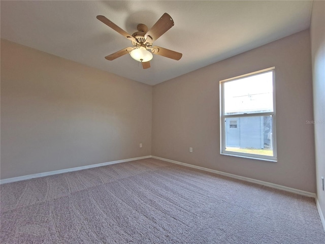 19855 Ellendale Dr, Land O Lakes, FL 34638 - spare room featuring light colored carpet, baseboards, and ceiling fan