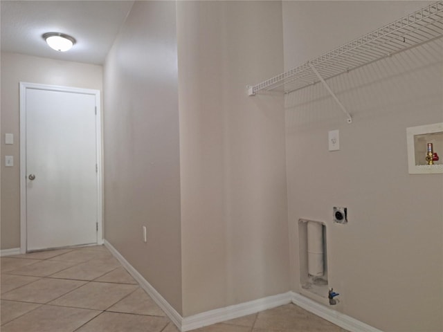 19855 Ellendale Dr, Land O Lakes, FL 34638 - laundry room featuring electric dryer hookup, hookup for a washing machine, baseboards, and light tile patterned floors