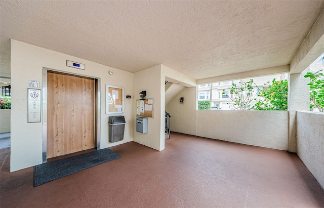 8210 Aquila St Unit 218, Port Richey, FL 34668 - foyer featuring tile patterned floors and a textured ceiling