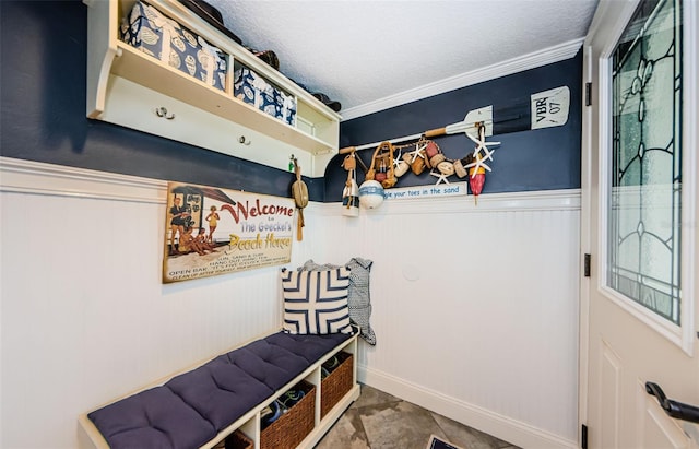 8210 Aquila St Unit 218, Port Richey, FL 34668 - mudroom featuring wainscoting, a textured ceiling, and crown molding