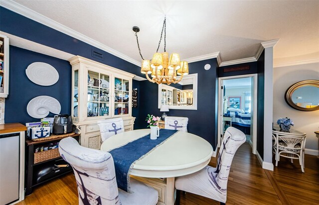 8210 Aquila St Unit 218, Port Richey, FL 34668 - dining area featuring a chandelier, wood finished floors, crown molding, and baseboards