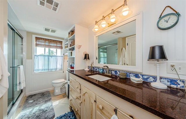 8210 Aquila St Unit 218, Port Richey, FL 34668 - full bathroom featuring a shower stall, toilet, tile patterned flooring, and vanity