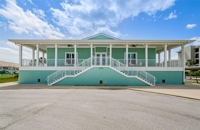 8210 Aquila St Unit 218, Port Richey, FL 34668 - view of front of property with stairs, a ceiling fan, and french doors