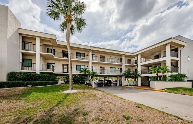 8210 Aquila St Unit 218, Port Richey, FL 34668 - view of property featuring covered parking