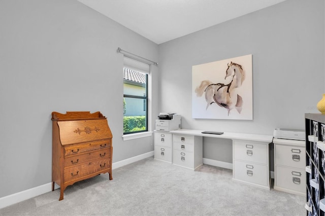 office space with baseboards and light carpet