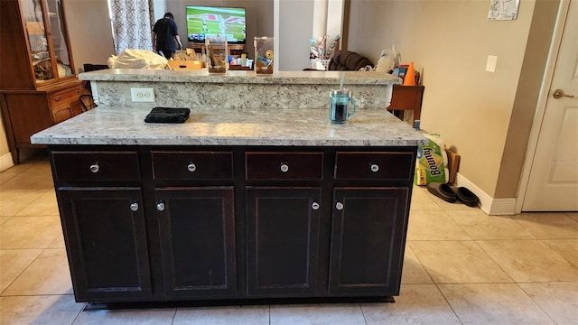 9007 49th Ave E, Palmetto, FL 34221 - kitchen featuring light tile patterned floors, baseboards, and a kitchen island