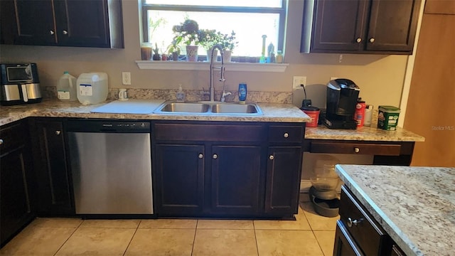 9007 49th Ave E, Palmetto, FL 34221 - kitchen with dishwasher, a sink, light tile patterned floors, and light countertops